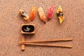 Assorted sushi set on a brown stone background. Japanese food sushi, soy sauce, chopsticks. Top view, copy space Royalty Free Stock Photo