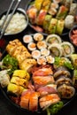 Assorted sushi set served on dark dark background. Top view of seafood, various maki rolls Royalty Free Stock Photo