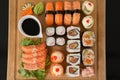 Assorted sushi set served on wooden tray against black background Royalty Free Stock Photo
