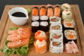 Assorted sushi set served on wooden tray against black background Royalty Free Stock Photo