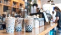 Assorted tapioca bubble teas on blurred coffee shop background with space for text