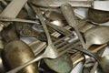 Assorted tarnished antique flatware on white