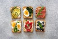 Assorted toasts with eggs, ham ,vegetables and fruits served on Royalty Free Stock Photo