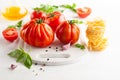 Assorted tomatoes with basil, garlic, spice and raw pasta for italian cuisine. Healthy food concept on white background Royalty Free Stock Photo