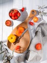 Assorted tomatoes on a kitchen wooden board. Colorful tomatoes of different varieties and colors. Organic and fresh vegetables Royalty Free Stock Photo