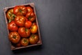 Assorted tomatoes in rustic crate