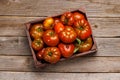 Assorted tomatoes in rustic crate