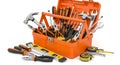 Assorted tools neatly organized in an orange toolbox with additional tools spread out on the floor Royalty Free Stock Photo