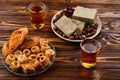 Assorted traditional eastern desserts with tea on wooden background.