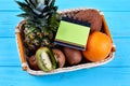 Assorted tropical fruits in basket.