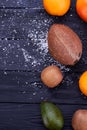 Assorted tropical fruits on black background.