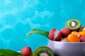 Assorted tropical fruits on turquoise background. Copy space Royalty Free Stock Photo