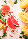 Slices and wedges of juicy watermelons and melons on rustic surface Royalty Free Stock Photo