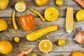 Assorted types of yellow fruits and vegetables on wooden background. Top view Royalty Free Stock Photo