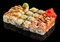 Assorted Uramaki Sushi set with ginger and wasabi isolated on black background with reflection Royalty Free Stock Photo