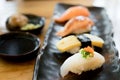 Assorted varieties of sushi platter. Raw fish sushi. Japanese food. Salmon burn, salmon, ika and tamago sushi in Japanese food re Royalty Free Stock Photo