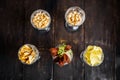 Assorted variety of beer bar snacks in glasses Royalty Free Stock Photo