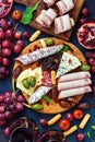 Assorted variety of snacks with red wine. Various sausages and cold meat, cheese with mold, fruit. Top view, flat lay Royalty Free Stock Photo