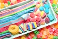 Assorted variety of sour candies includes extreme sour soft fruit chews, keys, tart candy belts and straws Royalty Free Stock Photo