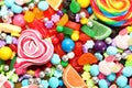 Assorted variety of sweet sugar candies includes lollipops, gummy bears, gum balls and sugar fruit slices Royalty Free Stock Photo