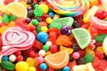 Assorted variety of sweet sugar candies includes lollipops, gummy bears, gum balls and sugar fruit slices Royalty Free Stock Photo