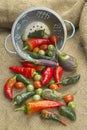 Assorted vegetables and colander on burlap