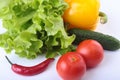 Assorted vegetables, fresh bell pepper, tomato, chilli pepper, cucumber and lettuce on white background Royalty Free Stock Photo