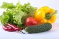 Assorted vegetables, fresh bell pepper, tomato, chilli pepper, cucumber and lettuce on white background Royalty Free Stock Photo