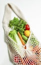 Assorted vegetables in mesh grocery bag isolated on white background Royalty Free Stock Photo