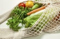 Assorted vegetables in mesh grocery bag isolated on white background Royalty Free Stock Photo