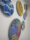 assorted wall hangings ..circular mosaic colorful tiles art