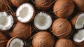 Assorted whole and halved coconuts with visible flesh