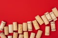 Assorted wine corks from white and red vine on red paper background with empty space for your text Royalty Free Stock Photo