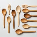 Assorted wooden spoons and a fork are arranged on a white surface. The utensils Royalty Free Stock Photo