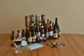 Assortment of artisan beer bottles and cans on table. Drinking at home in pandemic times