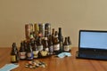 Assortment of artisan beer bottles and cans on table. Drinking at home in pandemic times. Work from home.