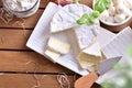 Assortment of artisanal dairy products on wood table top view