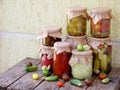 Assortment autumn preserves. Jars of pickled vegetables and jam. Royalty Free Stock Photo