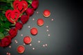 Tasty macaroon on black background with red roses Royalty Free Stock Photo