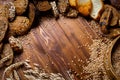 Assortment of baked bread on wooden table background