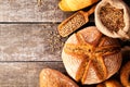 Assortment of baked bread on wooden table background Royalty Free Stock Photo