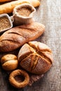 Assortment of baked bread on wooden table background Royalty Free Stock Photo