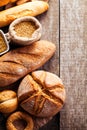 Assortment of baked bread on wooden table background Royalty Free Stock Photo
