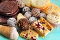 Assortment of baked sweet treats, including chocolate rum balls, vanilla cookies, raspberry squares and a cupcake with maple icing Royalty Free Stock Photo