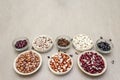 Assortment of beans on a stone background. Crimson cranberry, red, painted pony, black turtle, brown, black-eyed, Jacob`s Cattle Royalty Free Stock Photo