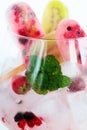 Assortment of Berry Popsicles with Mint Leaves on Ice Cubes Royalty Free Stock Photo