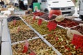 Assortment of black and green olives, dried tomatoes and pickled vegetables at market stand in Sciacca, Sicily, Italy.