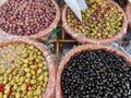 Assortment of black and green olives at market stand in Domodossola, Italy.