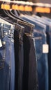 Assortment of blue and black jeans displayed in shopping center