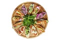 Assortment of bruschettas with different toppings served on a round wooden plate. Appetizing popular buffet snacks. Top view. Royalty Free Stock Photo